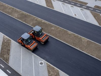 aerial-view-orange-vibratory-asphalt-roller-compactor-new-pavement_181624-49122